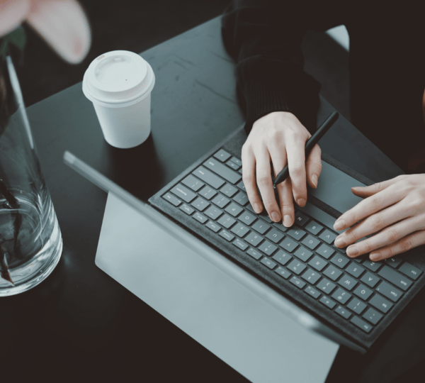 A worker on his laptop with a cup of coffee